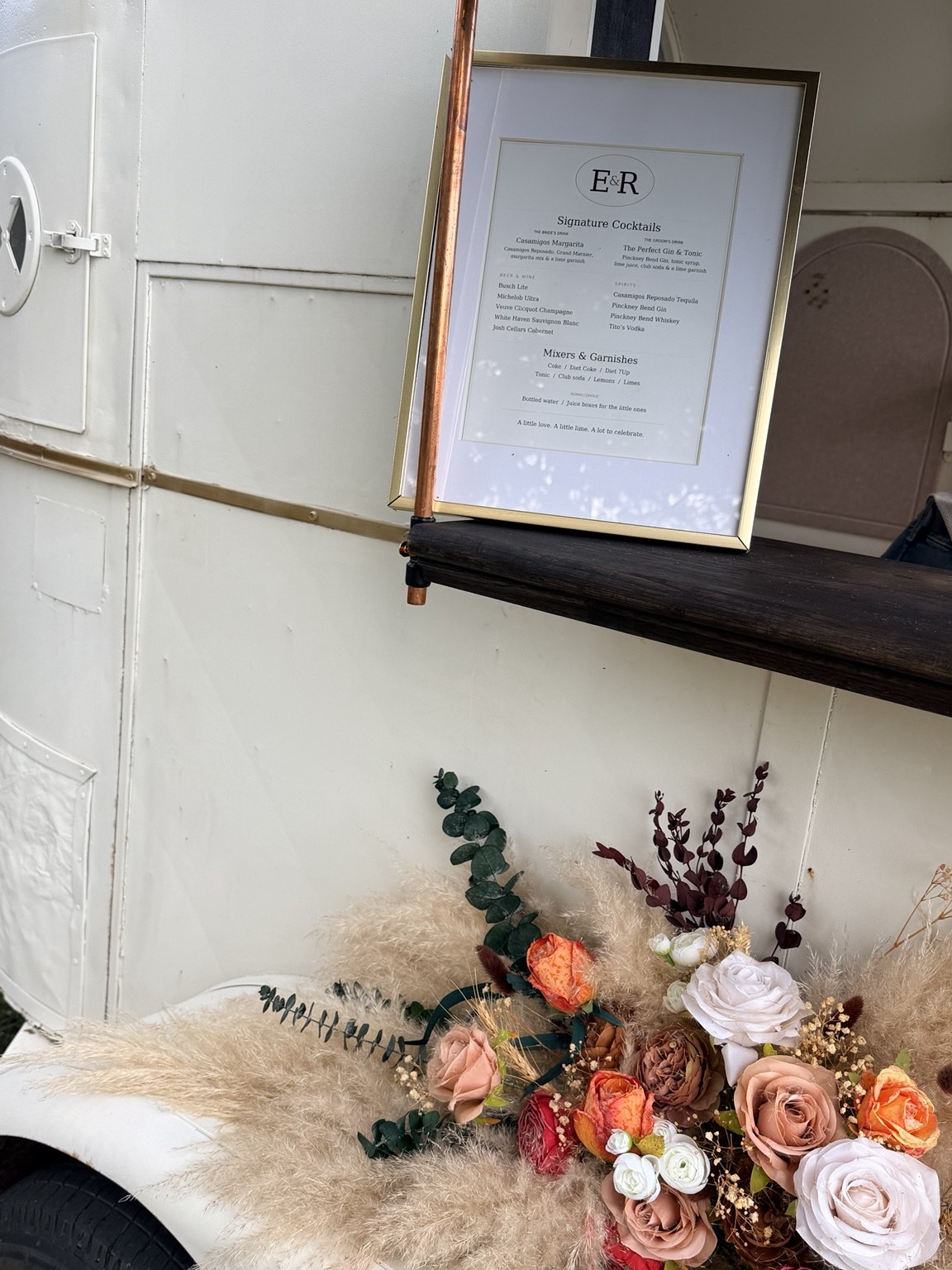 Personalized event drink menu displayed at the trailer with flowers